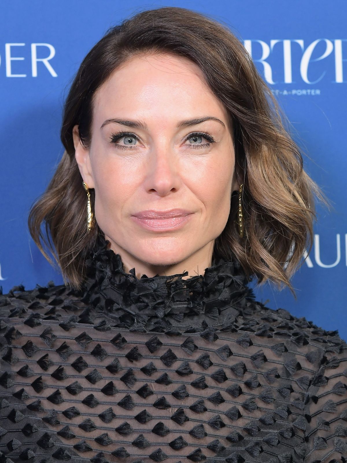 Claire Forlani's free-moving long hair with one side tucked behind